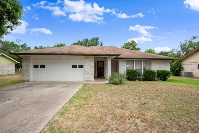 7104 Greenock St, Austin, TX 78749 - ranch-style house featuring a garage, concrete driveway, a front lawn, and central air condition unit