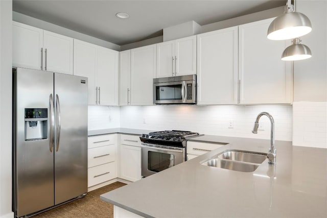 2724 Treble Ln Unit 324, Austin, TX 78704 - kitchen with appliances with stainless steel finishes, a sink, white cabinetry, tasteful backsplash, and decorative light fixtures