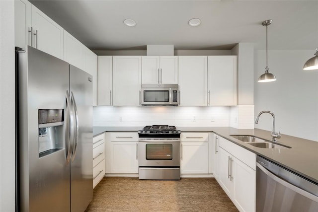 2724 Treble Ln Unit 324, Austin, TX 78704 - kitchen featuring stainless steel appliances, a sink, white cabinets, decorative light fixtures, and recessed lighting