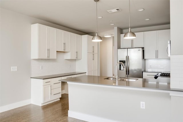 2724 Treble Ln Unit 324, Austin, TX 78704 - kitchen with stainless steel appliances, a sink, decorative backsplash, recessed lighting, and a peninsula