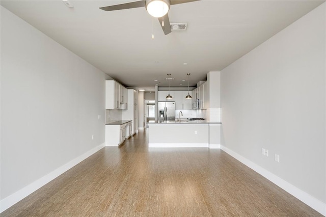 2724 Treble Ln Unit 324, Austin, TX 78704 - unfurnished living room featuring ceiling fan, a sink, baseboards, and dark wood-type flooring