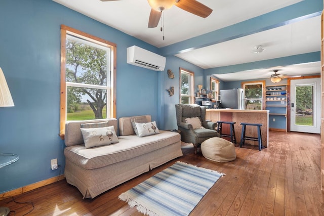 10843 US Highway 90 W, Harwood, TX 78632 - living area featuring an AC wall unit, a ceiling fan, wood-type flooring, and plenty of natural light