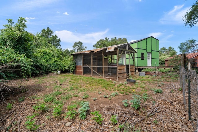 10843 US Highway 90 W, Harwood, TX 78632 - back of house with exterior structure, an outdoor structure, and board and batten siding