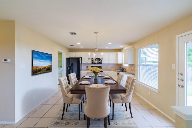 1214 Hensley Dr, Leander, TX 78641 - dining area with light tile patterned floors, a chandelier, baseboards, and recessed lighting