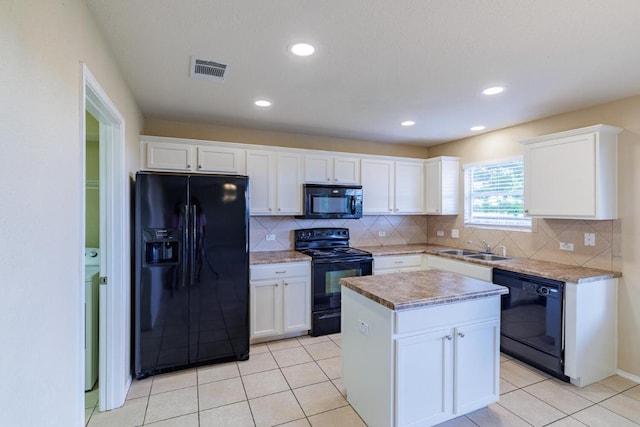 1214 Hensley Dr, Leander, TX 78641 - kitchen with black appliances, backsplash, a sink, a kitchen island, and recessed lighting