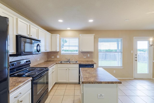 1214 Hensley Dr, Leander, TX 78641 - kitchen featuring black appliances, a sink, a center island, decorative backsplash, and light tile patterned floors