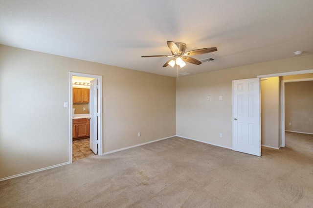 1214 Hensley Dr, Leander, TX 78641 - unfurnished bedroom with light colored carpet, baseboards, a ceiling fan, and ensuite bathroom