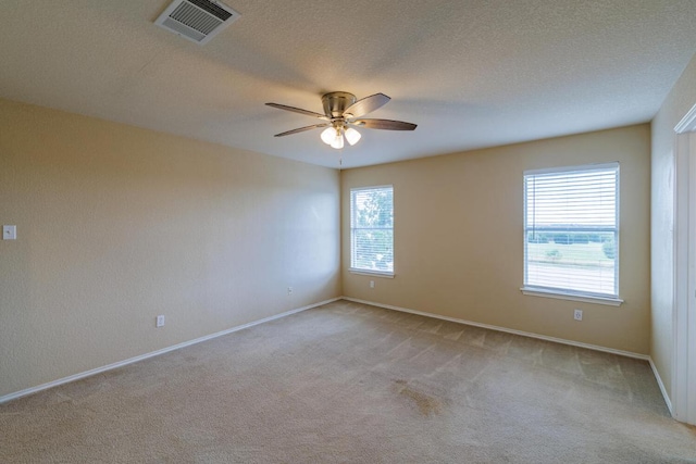 1214 Hensley Dr, Leander, TX 78641 - unfurnished room with light carpet, ceiling fan, baseboards, and a textured ceiling