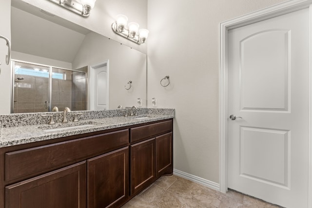 4162 Kingsley Ave, Round Rock, TX 78681 - full bathroom featuring double vanity, a stall shower, baseboards, and lofted ceiling
