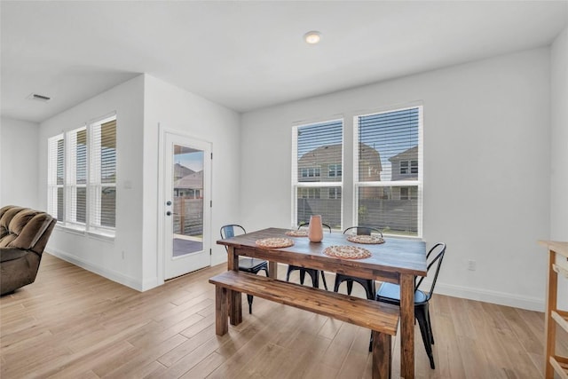 240 Harbors Ln, Leander, TX 78641 - dining area with baseboards, light wood-type flooring, and plenty of natural light