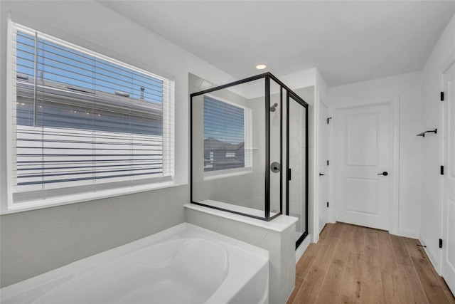 240 Harbors Ln, Leander, TX 78641 - full bath featuring a bath, a shower stall, plenty of natural light, and wood finished floors