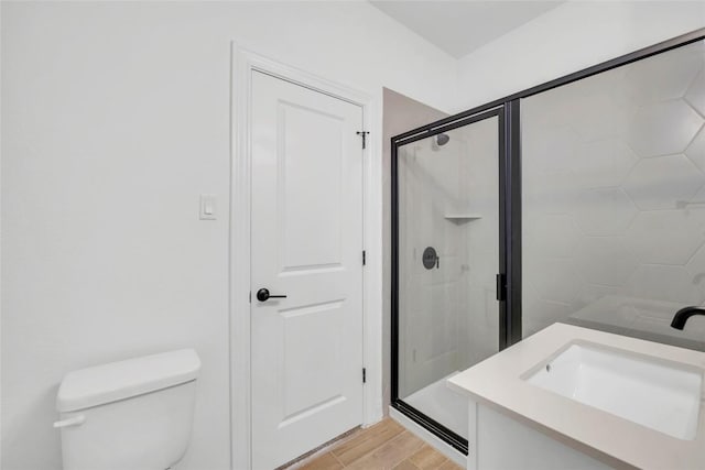 240 Harbors Ln, Leander, TX 78641 - bathroom with a stall shower, toilet, wood finished floors, and vanity