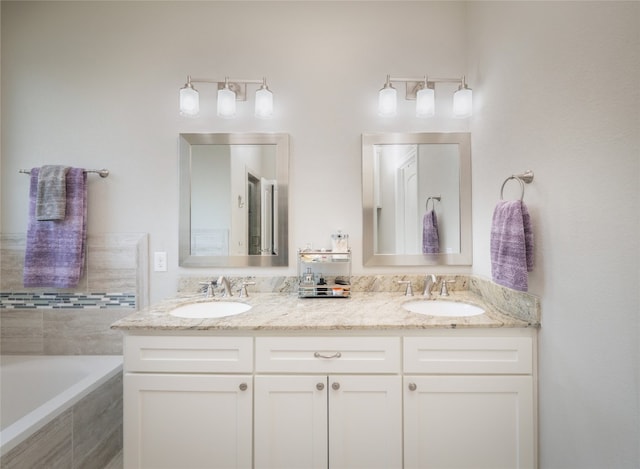 128 Naalehu Ct, Bastrop, TX 78602 - full bath with double vanity and tiled bath