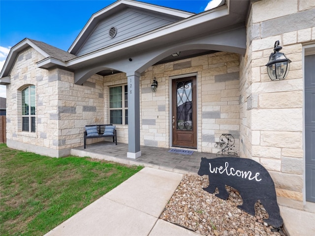 128 Naalehu Ct, Bastrop, TX 78602 - doorway to property featuring stone siding and a porch