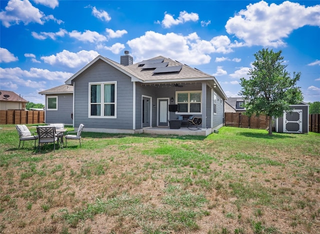 128 Naalehu Ct, Bastrop, TX 78602 - rear view of property with a patio, solar panels, a chimney, and roof with shingles