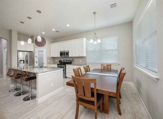 128 Naalehu Ct, Bastrop, TX 78602 - dining area with recessed lighting, baseboards, a chandelier, and arched walkways