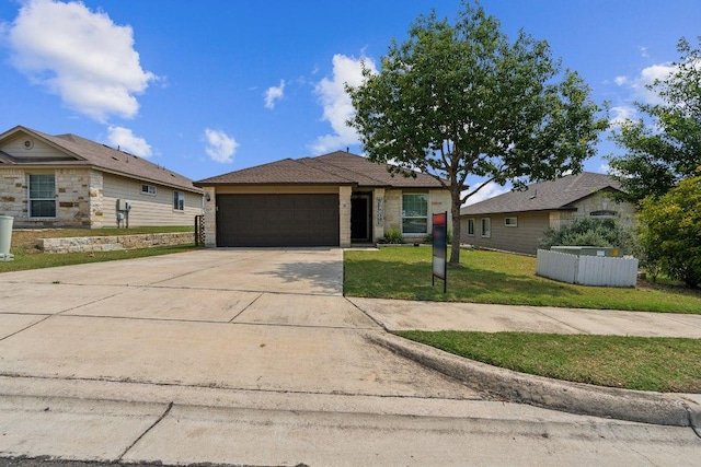 217 Hoya Ln, San Marcos, TX 78666 - view of front of house featuring an attached garage, driveway, and a front lawn