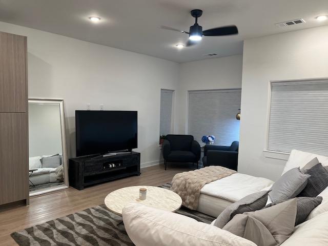 4802 S Congress Ave Unit 121, Austin, TX 78745 - living area with ceiling fan and wood finished floors