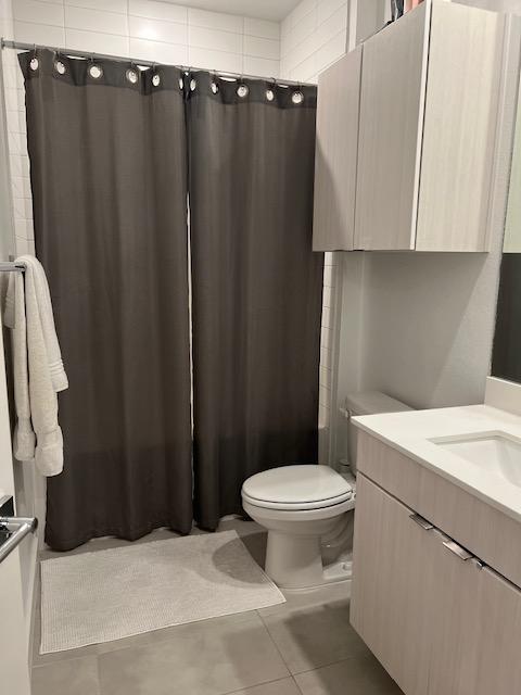 4802 S Congress Ave Unit 121, Austin, TX 78745 - full bath featuring vanity, tile patterned flooring, and a shower with curtain