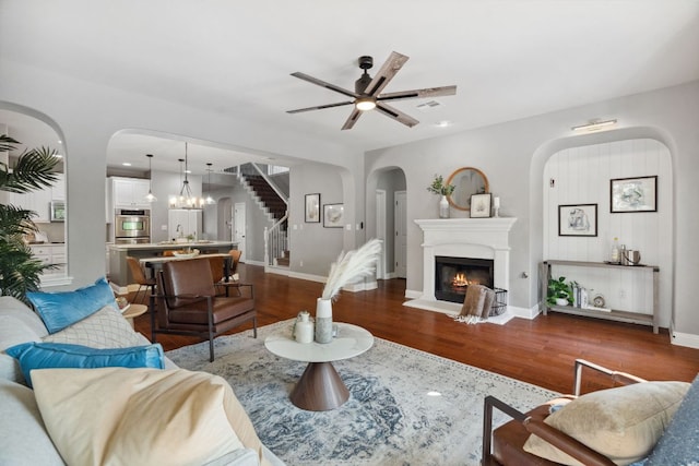 7820 Oteka Cv, Austin, TX 78735 - living area with arched walkways, stairway, wood finished floors, and ceiling fan