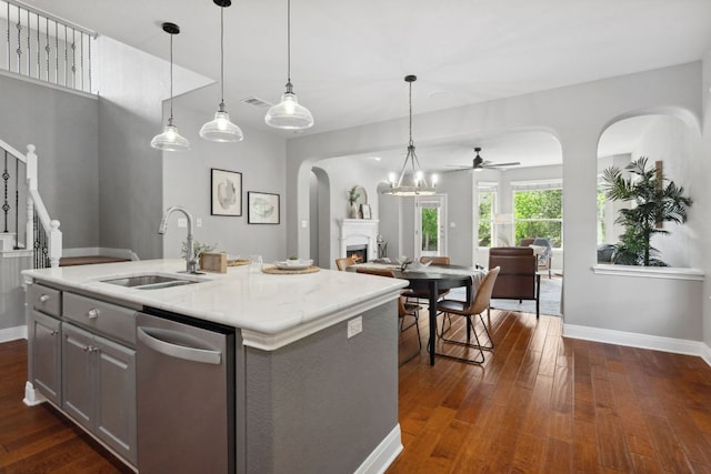 7820 Oteka Cv, Austin, TX 78735 - kitchen featuring dishwasher, arched walkways, open floor plan, dark wood-style flooring, and a ceiling fan