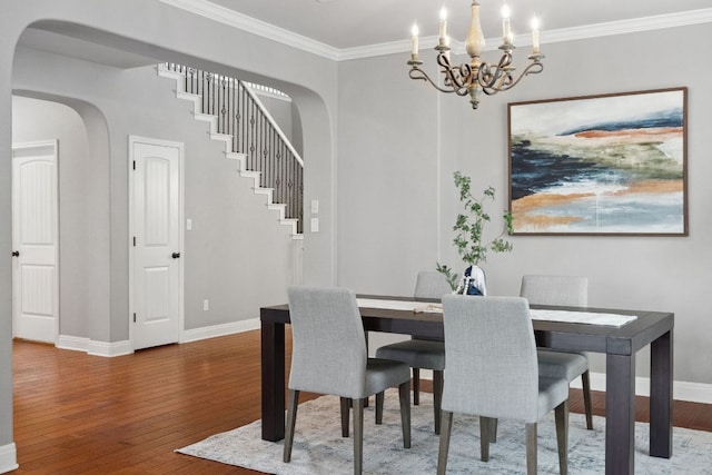 7820 Oteka Cv, Austin, TX 78735 - dining area featuring arched walkways, hardwood / wood-style flooring, ornamental molding, a chandelier, and stairway