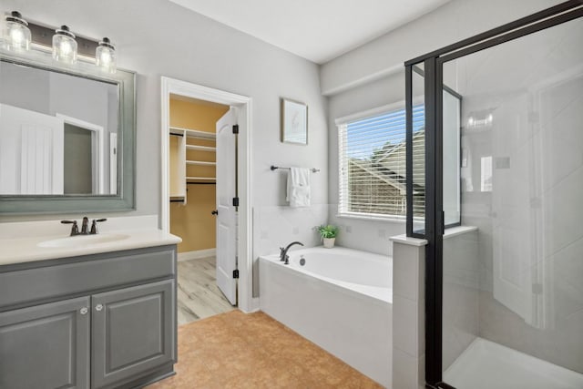 7820 Oteka Cv, Austin, TX 78735 - full bath featuring a stall shower, a bath, vanity, and a walk in closet