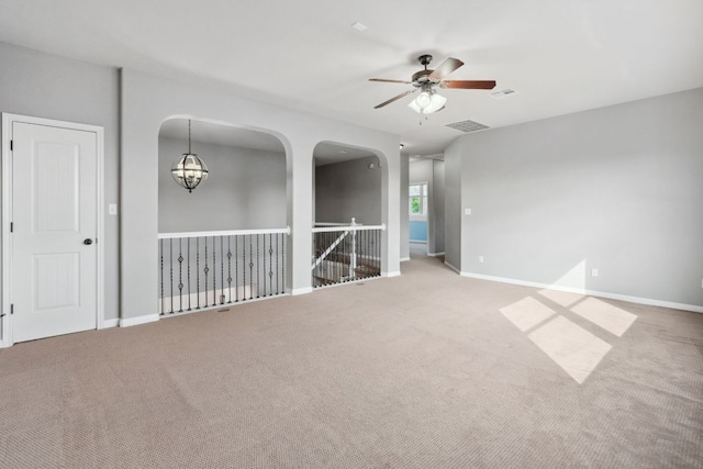 7820 Oteka Cv, Austin, TX 78735 - carpeted empty room featuring a ceiling fan, baseboards, and a chandelier