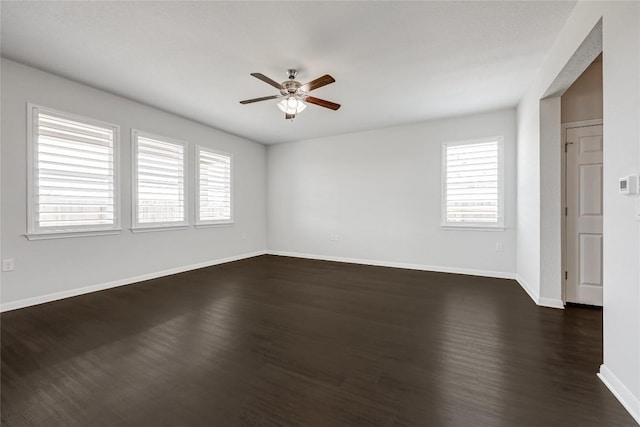825 Fortrose Ter, Pflugerville, TX 78660 - empty room featuring ceiling fan, plenty of natural light, dark wood-type flooring, and baseboards