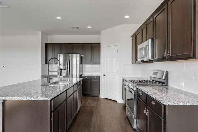 825 Fortrose Ter, Pflugerville, TX 78660 - kitchen featuring stainless steel appliances, a sink, dark wood-style floors, dark brown cabinetry, and recessed lighting