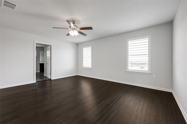 825 Fortrose Ter, Pflugerville, TX 78660 - unfurnished room featuring dark wood-type flooring, ceiling fan, and baseboards