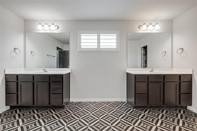 825 Fortrose Ter, Pflugerville, TX 78660 - bathroom with tile patterned floors, two vanities, baseboards, and a shower