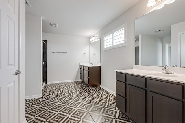 825 Fortrose Ter, Pflugerville, TX 78660 - full bath with tile patterned floors, two vanities, a shower stall, and baseboards