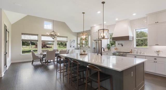 LOT13 Ridgeway Trl, Johnson City, TX 78636 - kitchen with a chandelier, appliances with stainless steel finishes, wall chimney range hood, dark wood finished floors, and light countertops