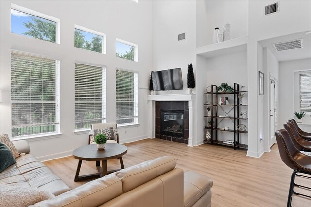 30 Stone Terrace Dr, Austin, TX 78734 - living area featuring a high ceiling, light wood-style floors, healthy amount of natural light, and a fireplace