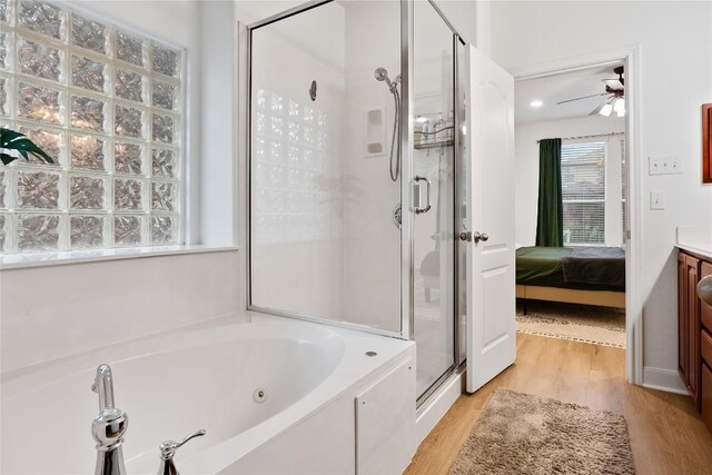 30 Stone Terrace Dr, Austin, TX 78734 - bathroom featuring a shower stall, a jetted tub, wood finished floors, a ceiling fan, and ensuite bath