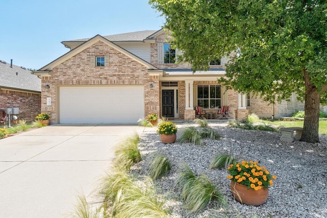 161 Serene Hollow Ln, Buda, TX 78610 - view of front of property featuring brick siding, covered porch, and concrete driveway