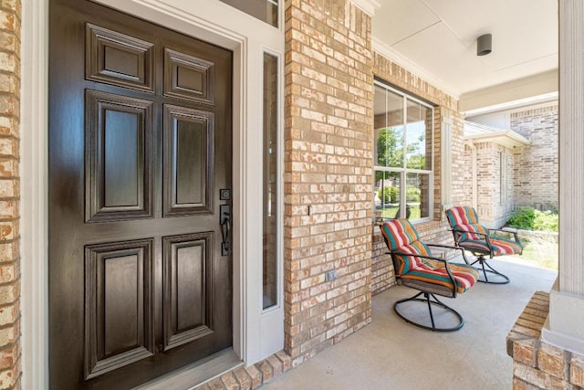161 Serene Hollow Ln, Buda, TX 78610 - doorway to property featuring a porch and brick siding