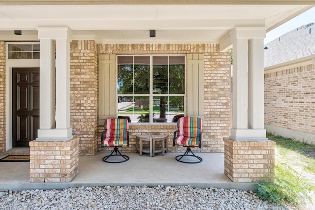 161 Serene Hollow Ln, Buda, TX 78610 - doorway to property featuring a porch and brick siding
