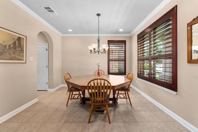 161 Serene Hollow Ln, Buda, TX 78610 - dining space featuring arched walkways, ornamental molding, a chandelier, light tile patterned flooring, and baseboards