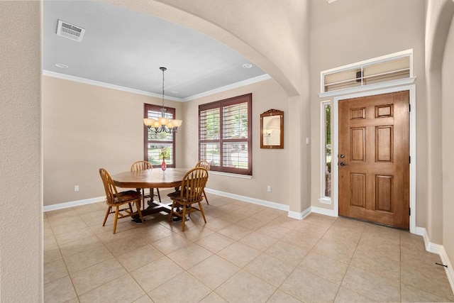 161 Serene Hollow Ln, Buda, TX 78610 - dining room with arched walkways, baseboards, crown molding, a chandelier, and light tile patterned floors