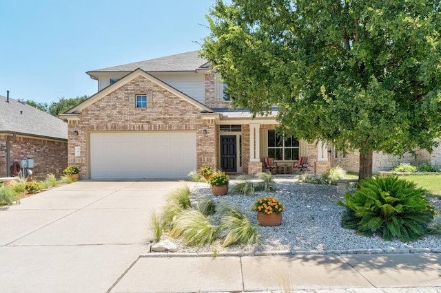 161 Serene Hollow Ln, Buda, TX 78610 - view of front of property featuring brick siding, an attached garage, a porch, and driveway