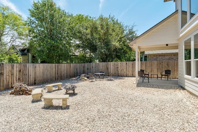 161 Serene Hollow Ln, Buda, TX 78610 - fenced backyard with an outdoor fire pit and a patio