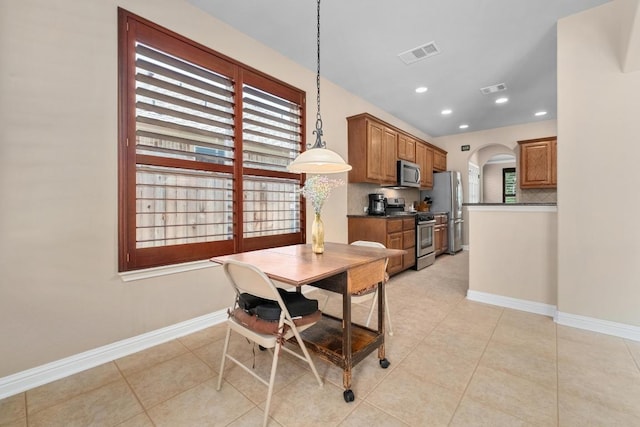 161 Serene Hollow Ln, Buda, TX 78610 - dining room with arched walkways, healthy amount of natural light, baseboards, and recessed lighting