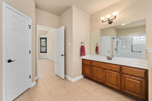 161 Serene Hollow Ln, Buda, TX 78610 - bathroom with tile patterned floors, a stall shower, vanity, and plenty of natural light