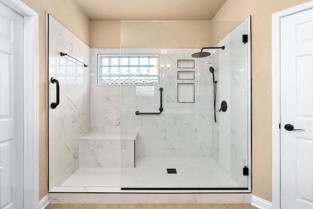 161 Serene Hollow Ln, Buda, TX 78610 - full bathroom featuring a marble finish shower and baseboards