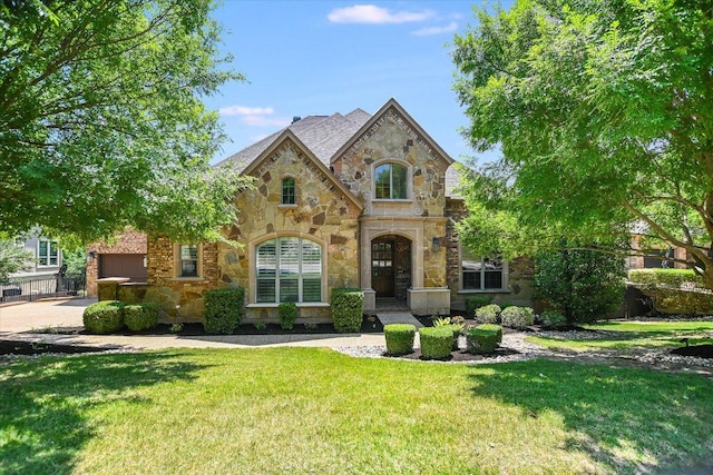 1016 Santaluz Path, Austin, TX 78732 - french provincial home with stone siding, a front yard, and an attached garage
