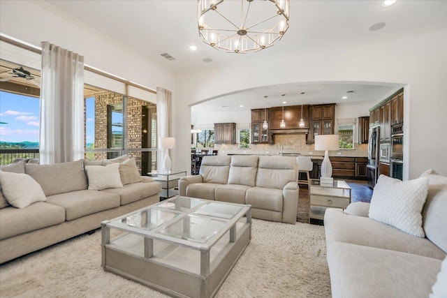 1016 Santaluz Path, Austin, TX 78732 - living room featuring arched walkways, recessed lighting, and a chandelier