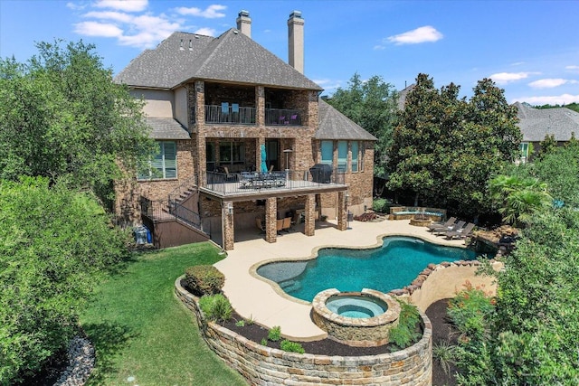 1016 Santaluz Path, Austin, TX 78732 - back of property featuring a balcony, a chimney, a pool with connected hot tub, and a patio area