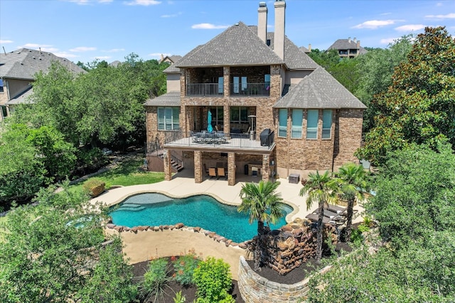 1016 Santaluz Path, Austin, TX 78732 - back of property featuring a balcony, a patio, brick siding, stairs, and roof with shingles